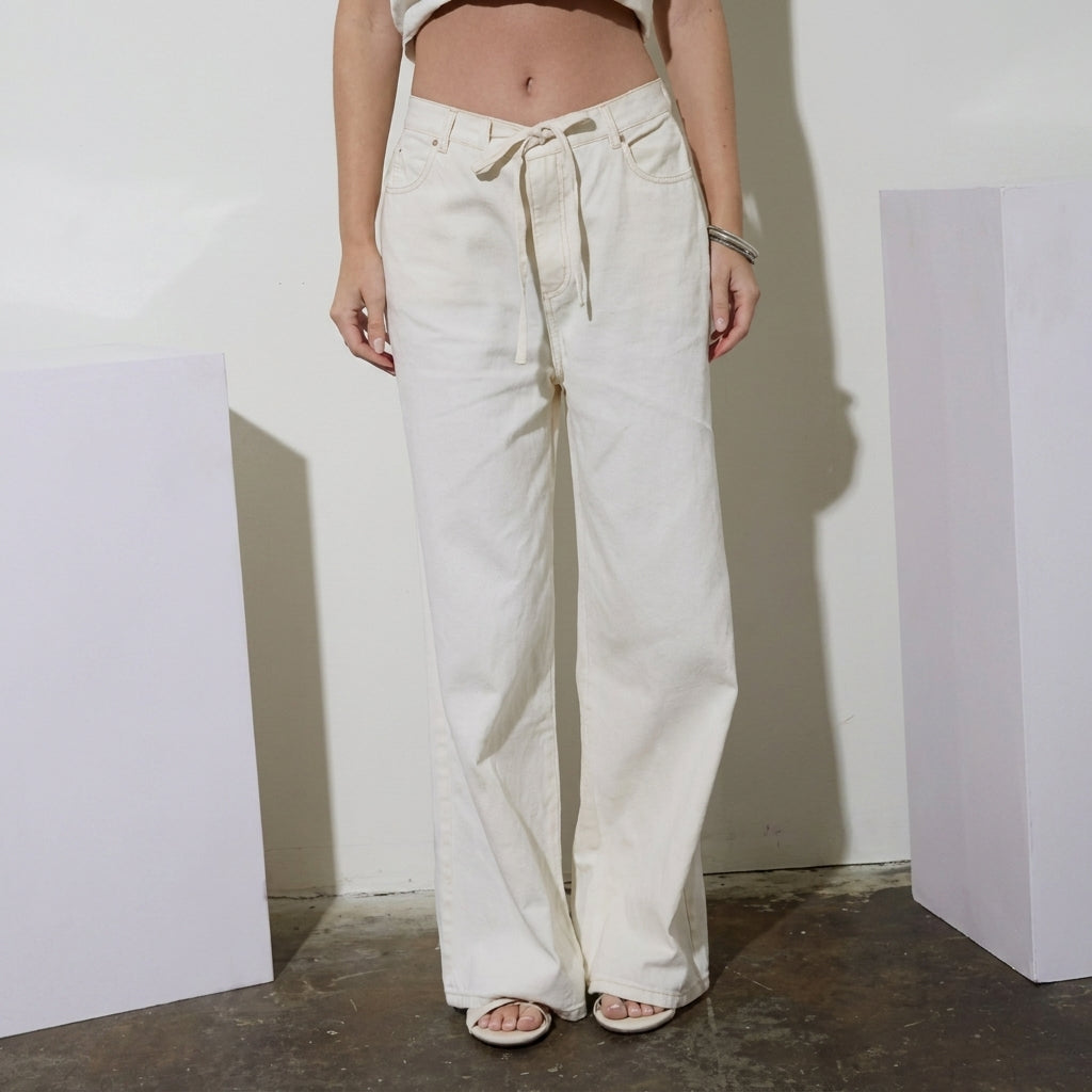 Person in white wide-leg pants and sandals.