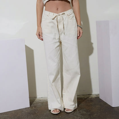 Person in white wide-leg pants and sandals.