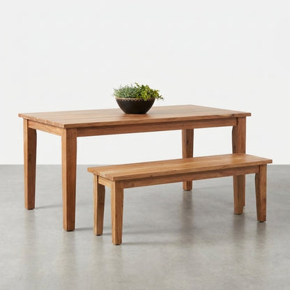 Wood table and bench set with a potted plant centerpiece.