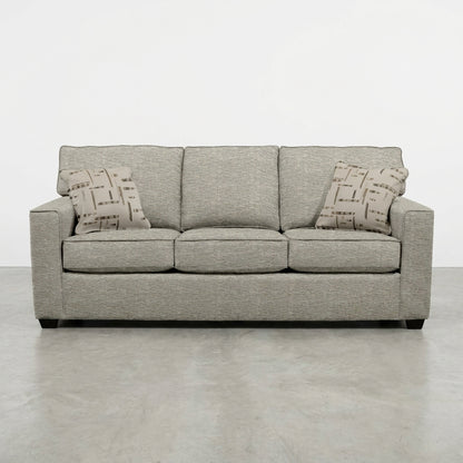 Gray sofa with geometric-patterned cushions.