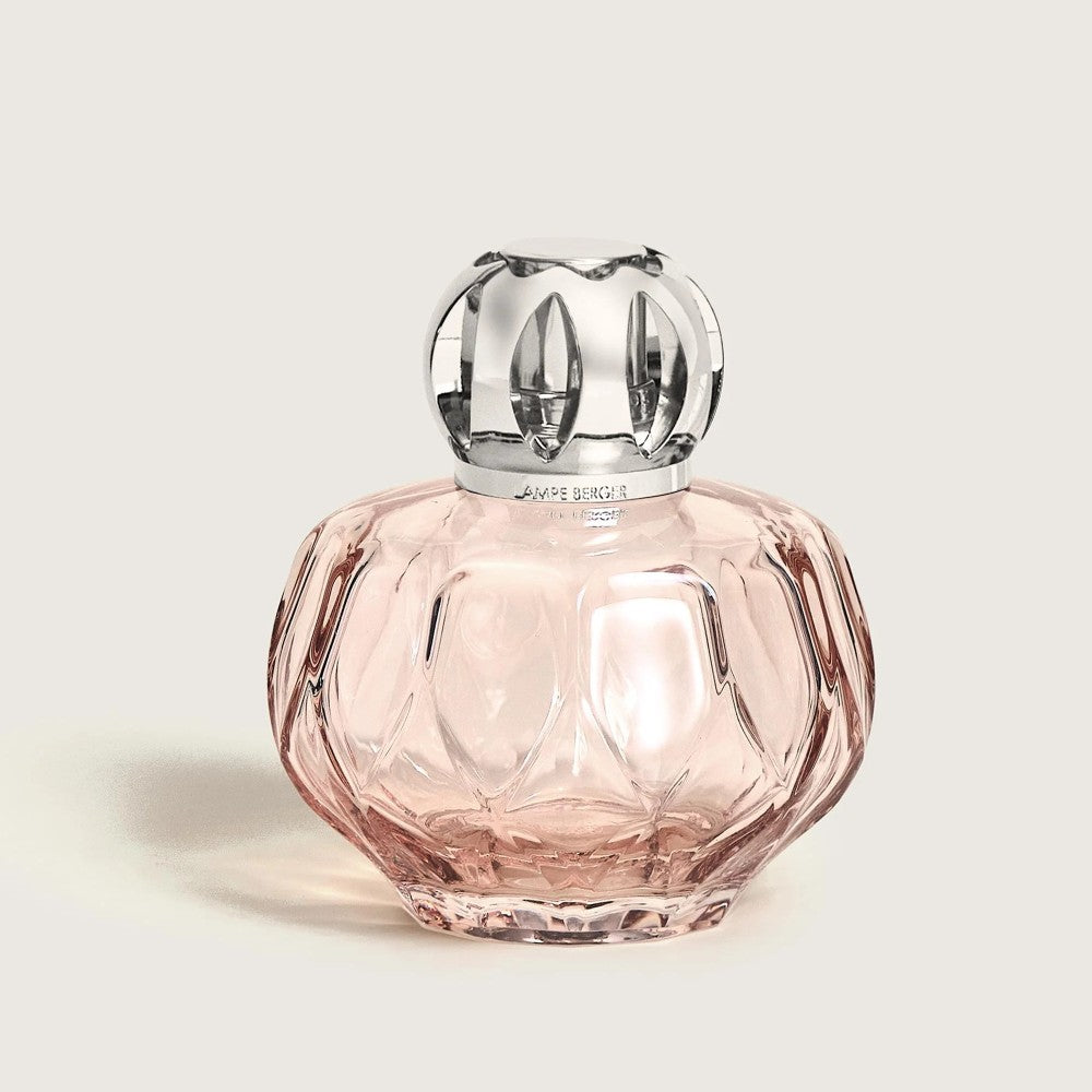 Elegant pink glass bottle with decorative silver cap.