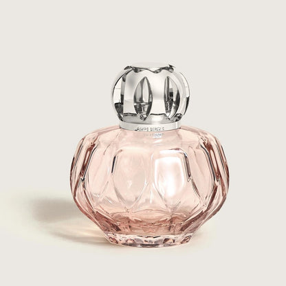 Elegant pink glass bottle with decorative silver cap.
