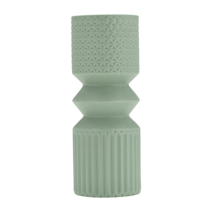Mint green textured ceramic vase with geometric patterns.