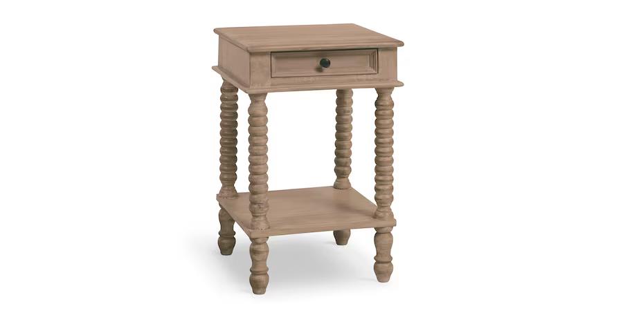 Wooden side table with a drawer and carved legs.