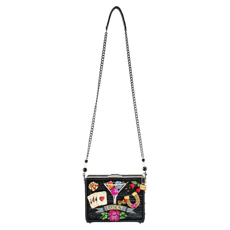 Black purse with colorful embellishments and chain strap.