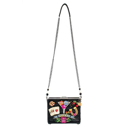 Black purse with colorful embellishments and chain strap.