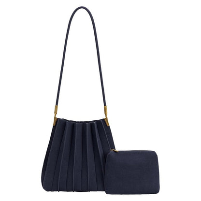 Navy pleated handbag and matching pouch with gold accents.