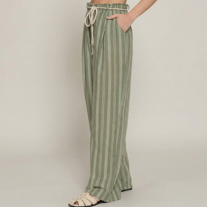 Striped green pants with rope tie and cream sandals.