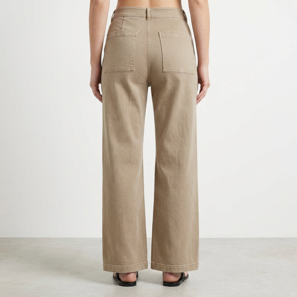 Person in high-waisted beige pants, seen from the back.