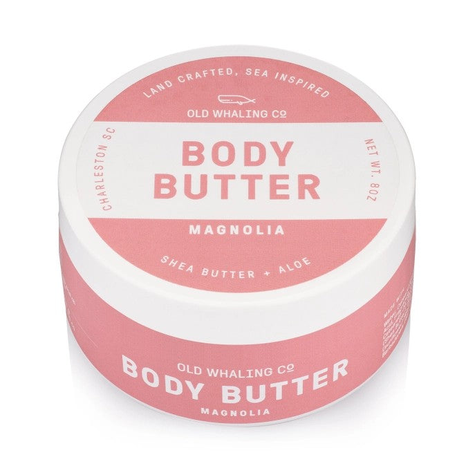 Pink and white jar of magnolia body butter, shea butter + aloe.