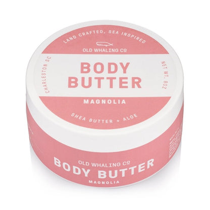 Pink and white jar of magnolia body butter, shea butter + aloe.