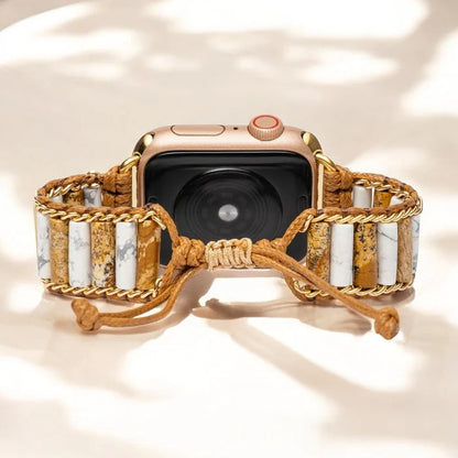 Smartwatch with a beaded, braided band on a light background.