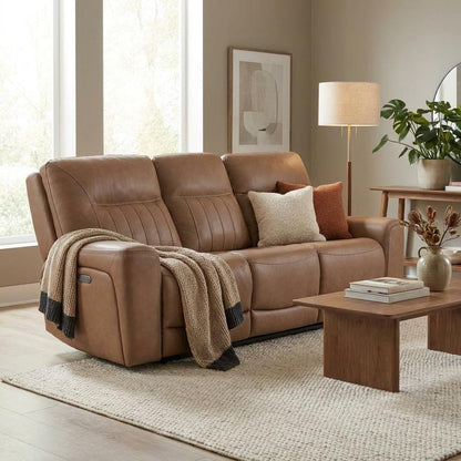 Cozy living room with a brown leather sofa and soft lighting.