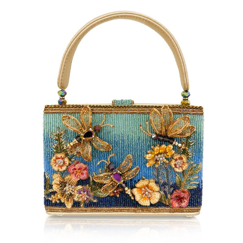 Ornate handbag with dragonfly and floral beaded design, featuring vibrant colors and textures.