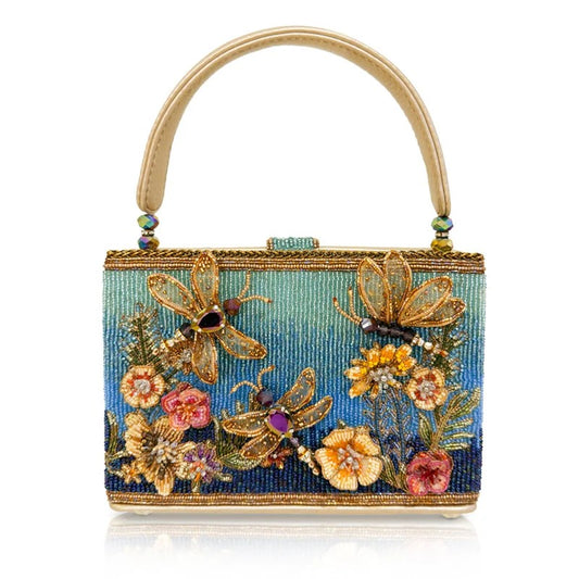 Ornate handbag with dragonfly and floral beaded design, featuring vibrant colors and textures.