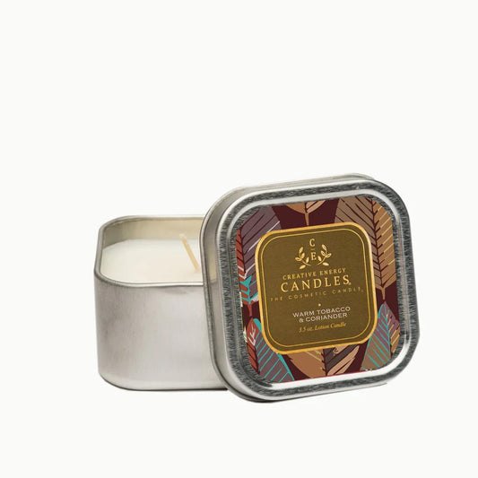 Tin candle labeled "Warm Tobacco & Coriander," lid with earthy design.