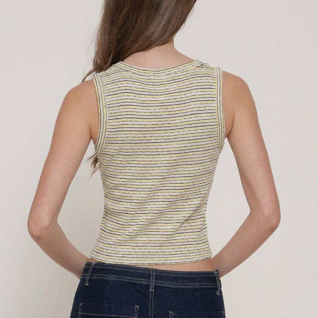 Person in a striped sleeveless top, seen from the back.