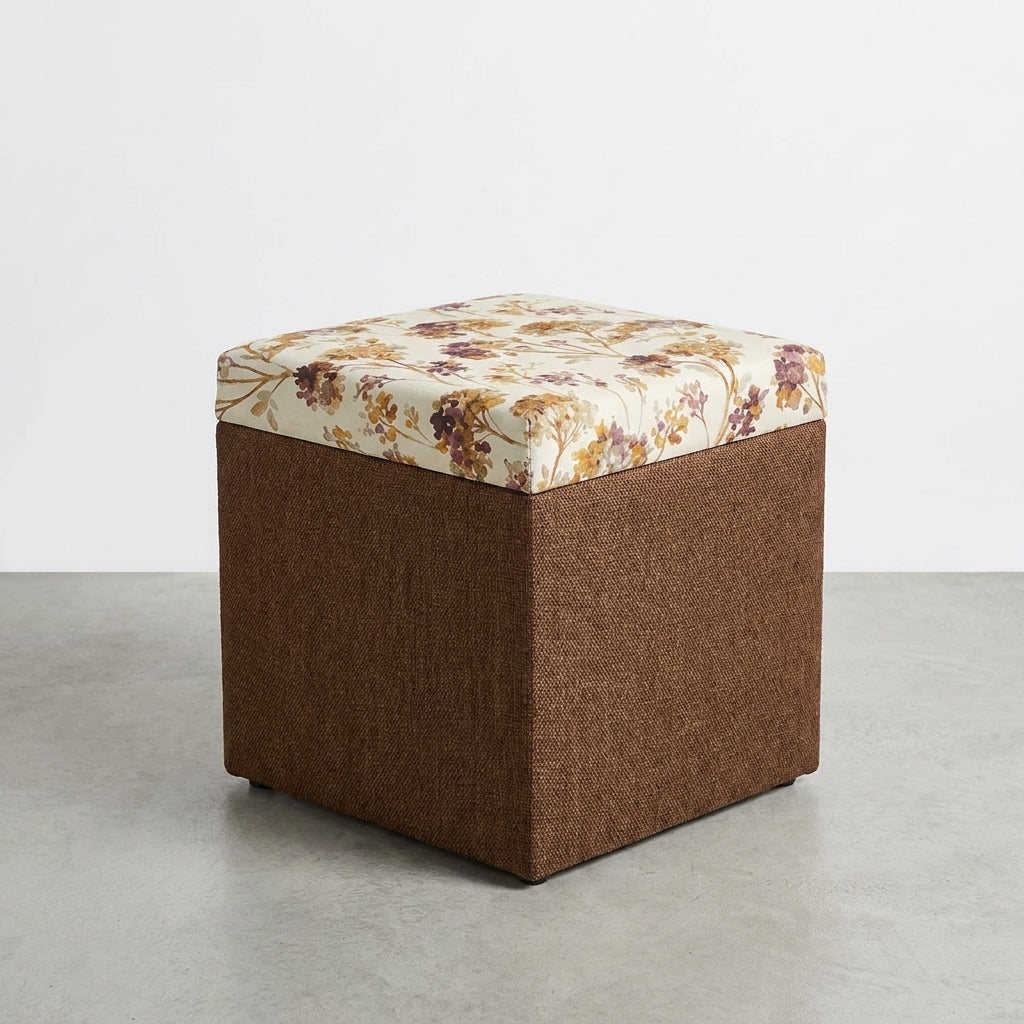 Two floral cushioned ottomans on a gray floor.