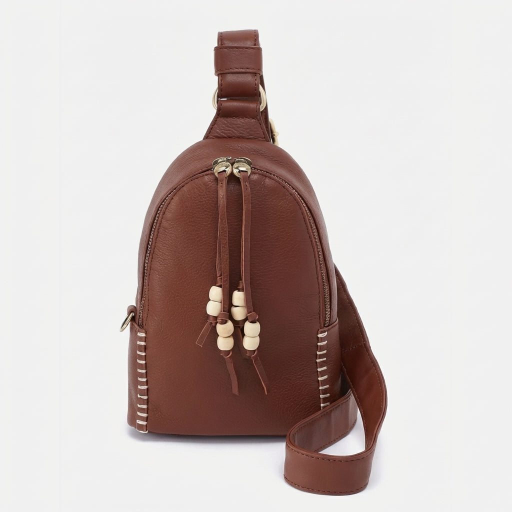 Brown leather bag with beige bead accents and stitching.