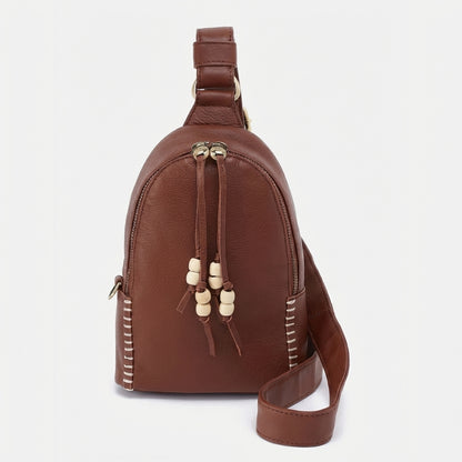 Brown leather bag with beige bead accents and stitching.