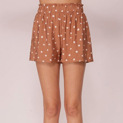 Brown polka dot shorts with elastic waistband, model not shown above the waist.