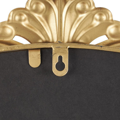 Close-up of ornate gold frame hanger with design detail.